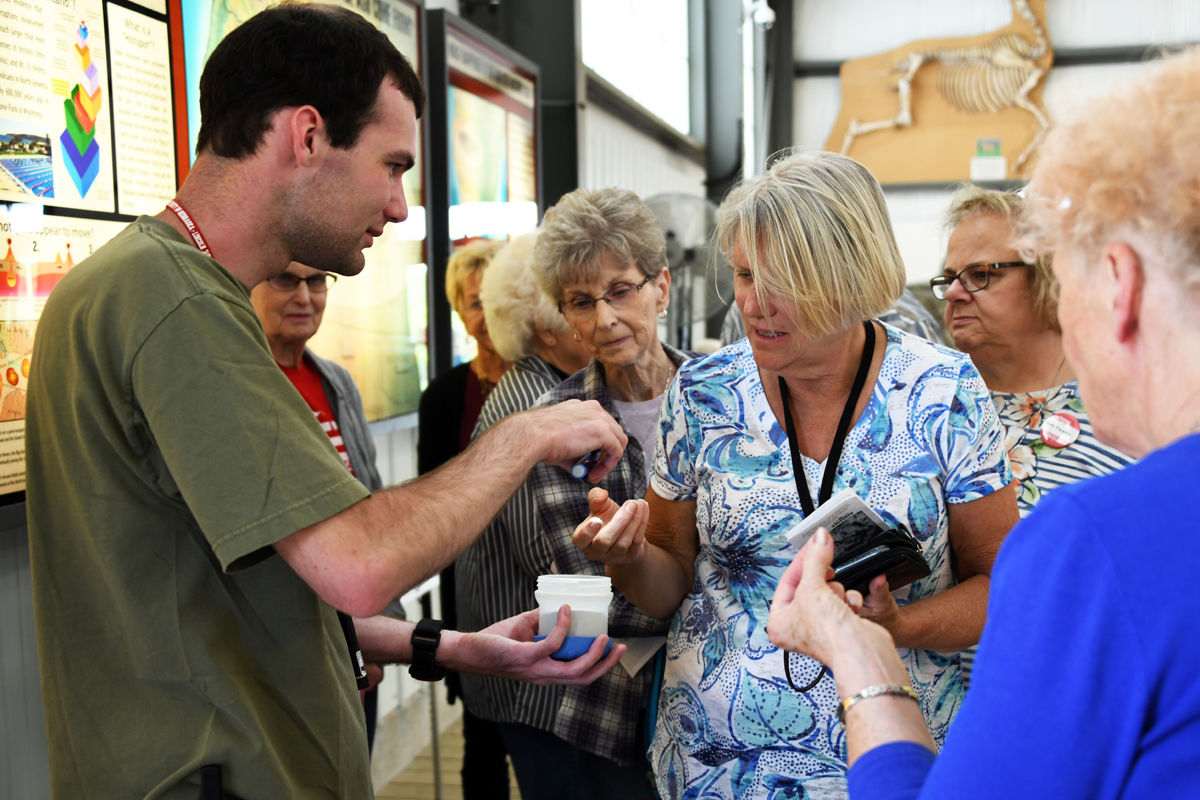 047 Marlene Larson and Linda Strotman feel the texture of the ashes.JPG
